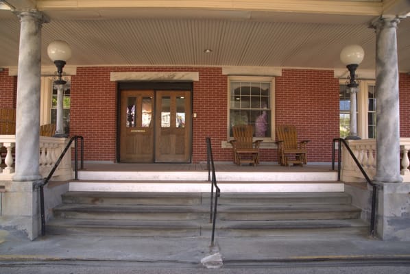 Entrance of the facility with rocking chairs on the porch