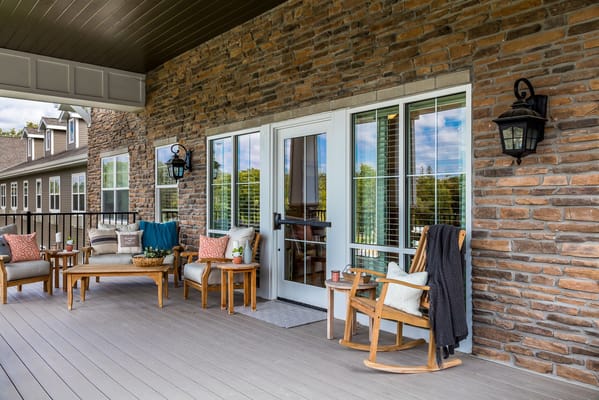 Cozy outdoor seating area with rockers and decorative pillows