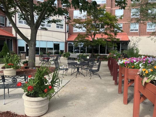 Outdoor seating area with flowers in planters