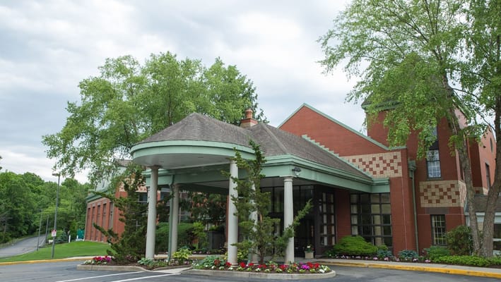 Front entrance of Evergreen Woods senior living facility with landscaping