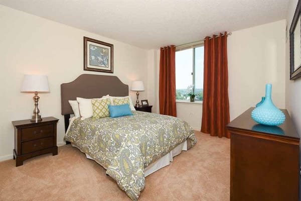 Comfortable bedroom with a bed, lamps, and window