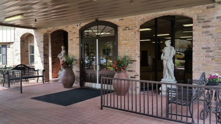 Front entrance with statues and planters at Flannery Oaks Guest House