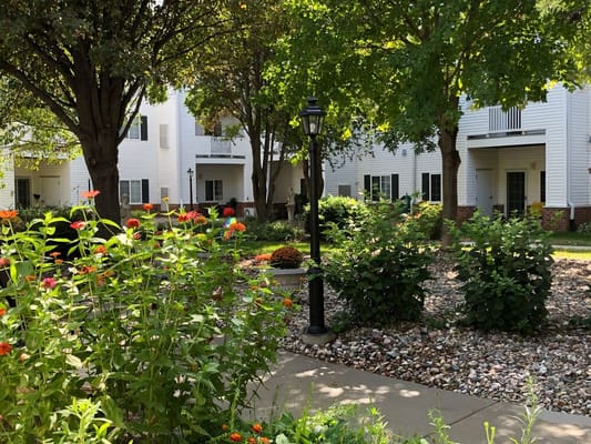 Beautiful garden area with walking path and lamp post
