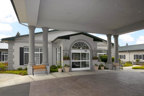 Main entrance of Garden Terrace Healthcare Center with columns and landscaped area