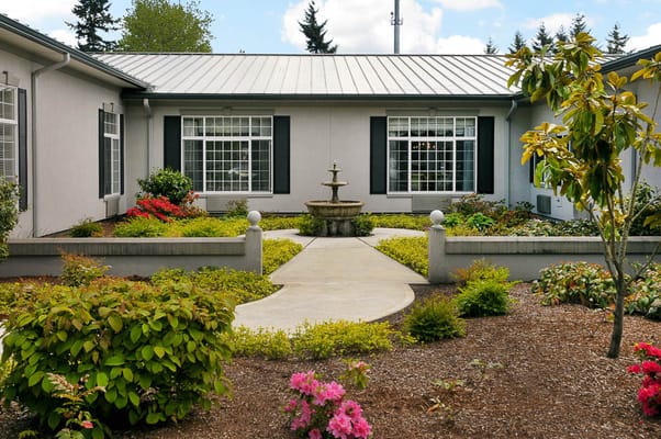 Manicured courtyard with fountain and colorful flowers