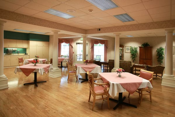 Spacious dining area with tables set for residents