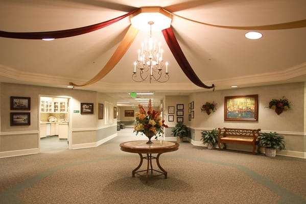 Lobby area with chandelier and floral arrangement