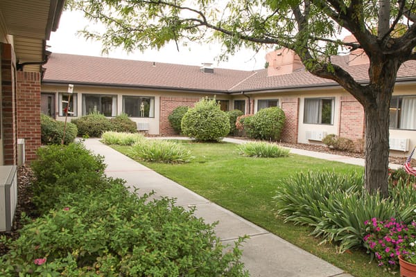 Courtyard with green bushes and flower beds at Garden Terrace at Aurora