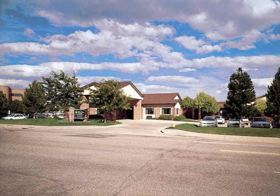 View of the entrance of Garden Terrace at Aurora surrounded by trees