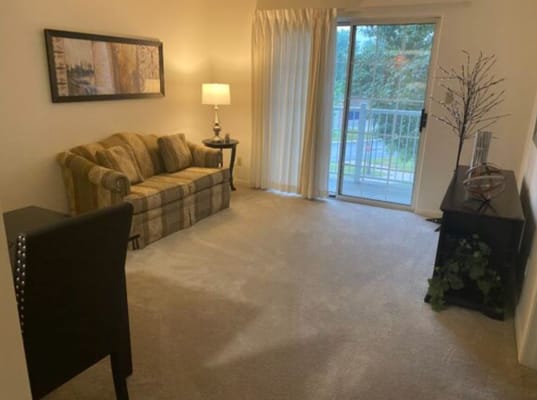 Bright living room with a couch and balcony access
