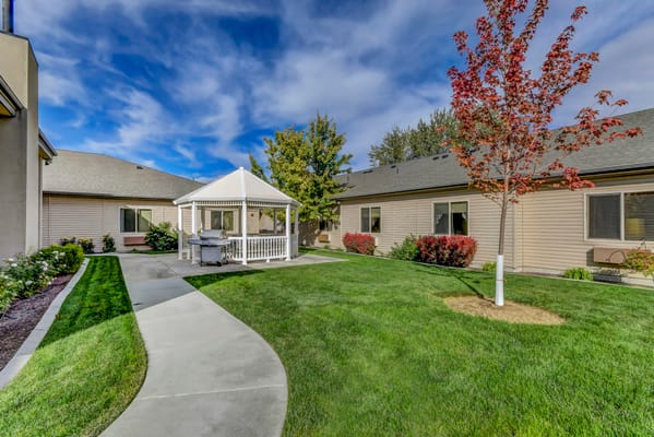 Well-maintained outdoor garden area with gazebo