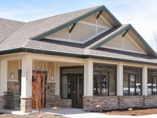 Front view of Green House Homes building with sloping roof