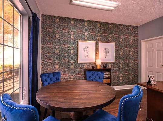 Cozy common area with decorative wallpaper and seating