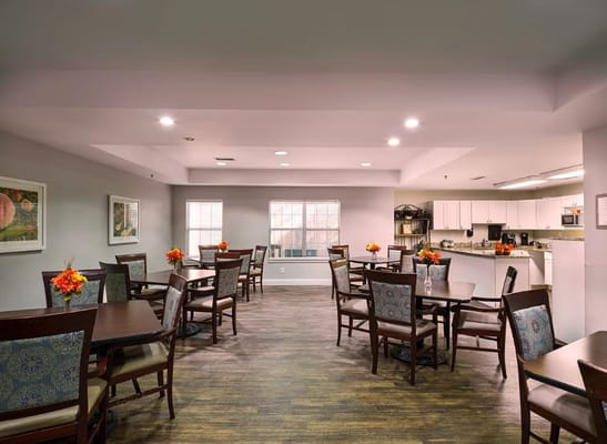 Bright and inviting dining area with tables and flowers