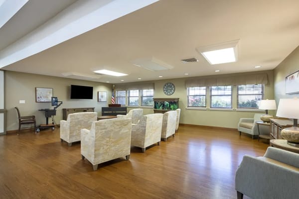 Spacious common area with comfortable seating and a television.