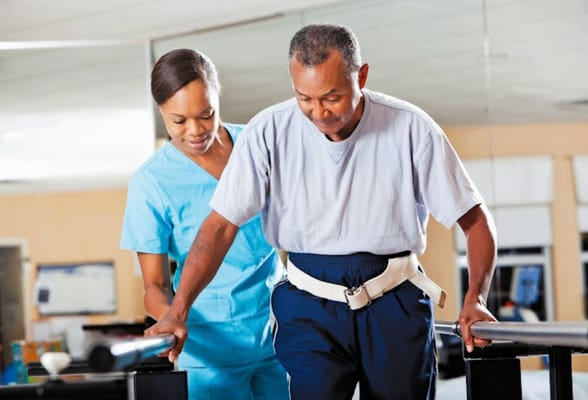 A staff member assisting a resident with therapy