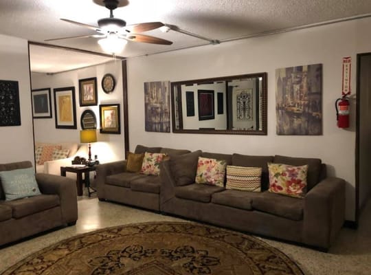 Cozy common area with comfortable seating and artwork