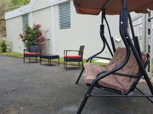 Outdoor seating area with a swing and chairs