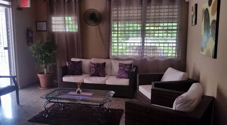 A cozy living room with comfortable seating and decorative pillows.