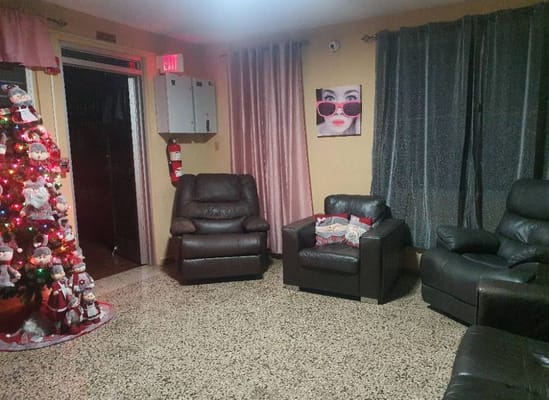 Cozy living room with leather chairs and a decorated Christmas tree