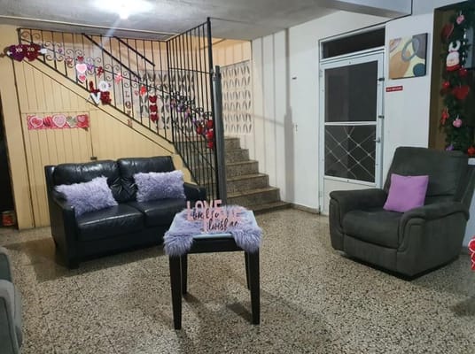 Living room with sofas and decor at Hogar de Envejecientes