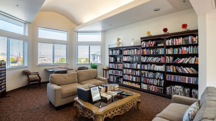 Comfortable seating area in a library with bookshelves and natural light