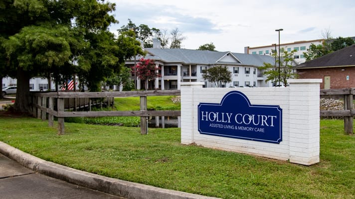 Exterior view of Holly Court Assisted Living with signage