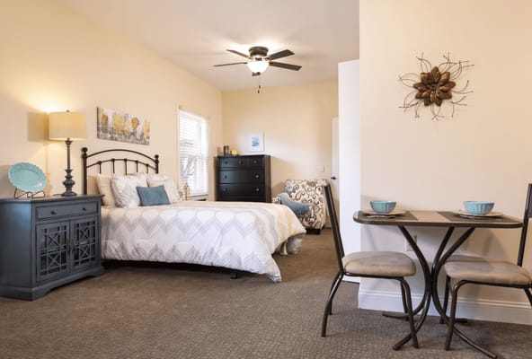 Cozy private resident room with a bed and table