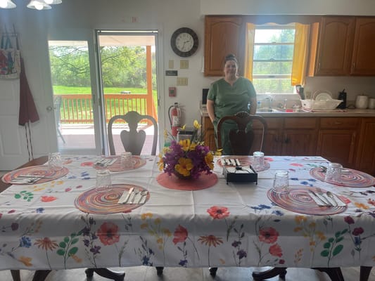 Bright dining area with a decorated table and staff member