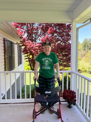 A resident enjoying the outdoor space with a walker