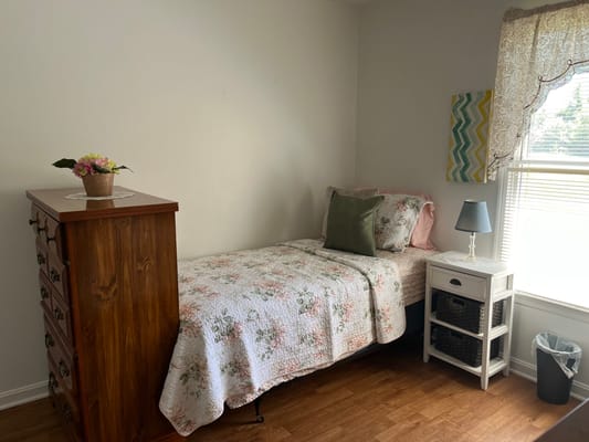 Cozy private bedroom with a bed and dresser