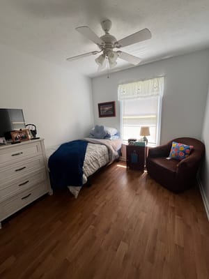 Cozy bedroom with single bed and armchair