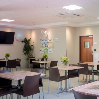 Bright dining room with tables and flowers