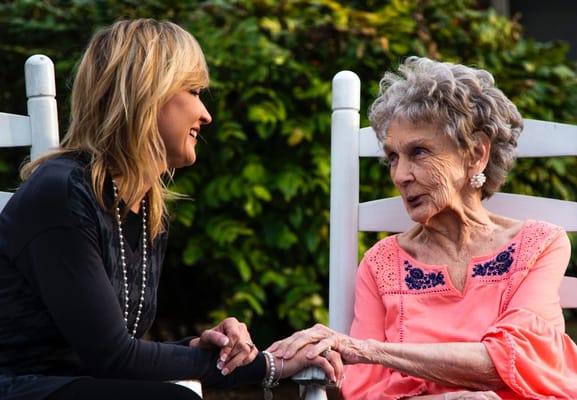 A caregiver and resident sharing a moment outdoors