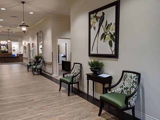 Interior hallway with decorative chairs and artwork