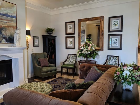 Cozy common area with comfortable seating and floral arrangements