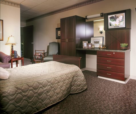 Cozy private resident room with furniture and TV