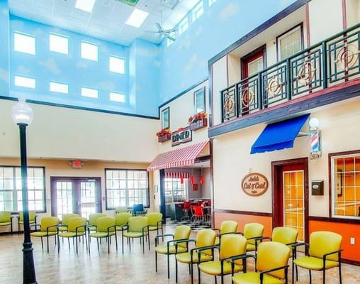 Brightly lit common area with seating and diner-themed decorations