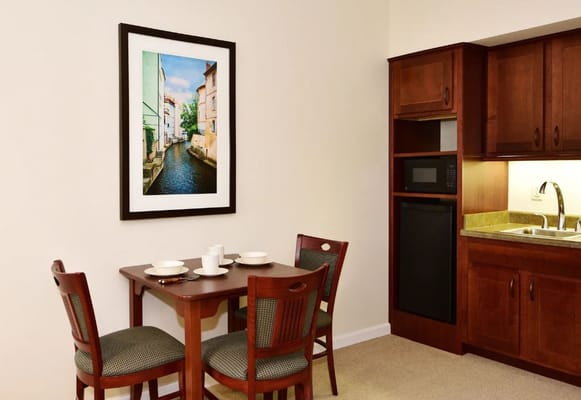 Cozy dining area with table and kitchenette