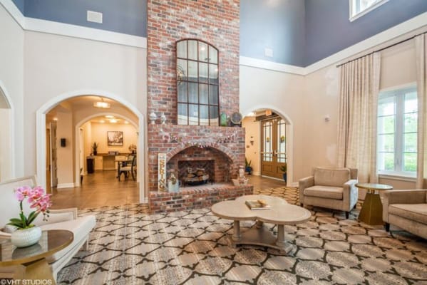 Elegant living room with a brick fireplace and comfortable seating.