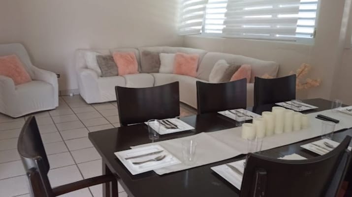 Cozy dining area featuring a long table and comfortable seating
