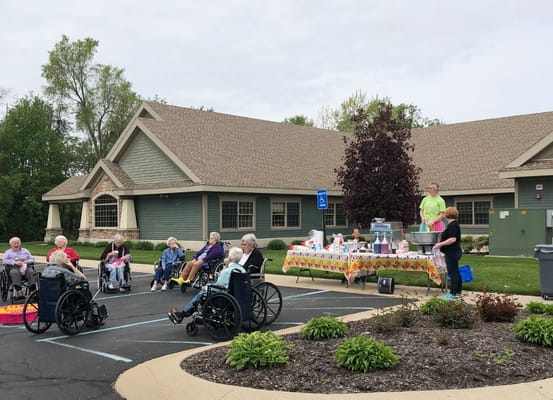 Residents enjoying an outdoor event with wheelchairs