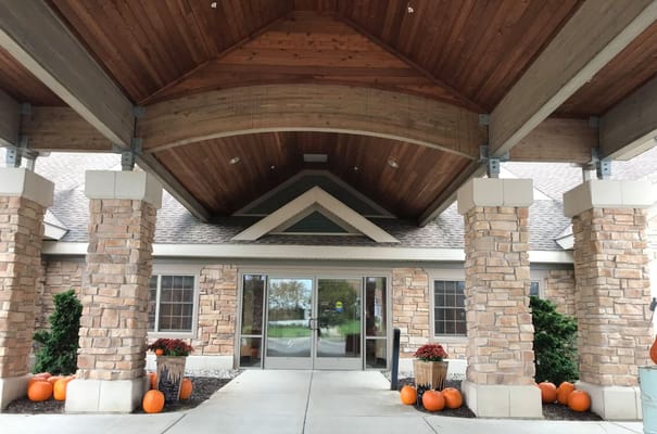 Entrance of a senior living facility decorated for fall
