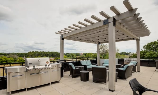 Outdoor lounge area with grill and seating