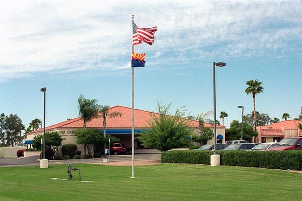 Exterior view of Mi Casa Nursing Center with flags