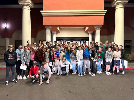 Group of people gathered outside the facility entrance