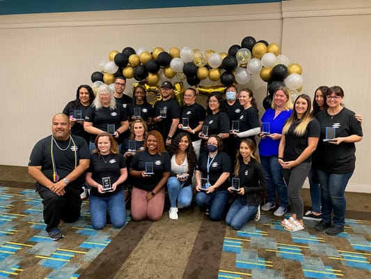 Staff celebrating achievements with awards and decorations