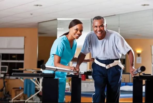 A staff member assisting a resident during therapy