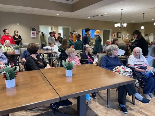 Residents and volunteers engaged in an indoor activity