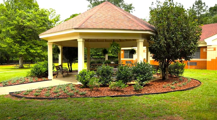 Outdoor gazebo surrounded by landscaped gardens
